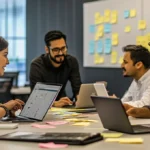 Collaborative team working in a modern office using laptops, sticky notes, and Kanban boards to represent agile teamwork and flexibility