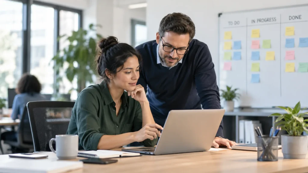 Employee and manager reviewing workload priorities to manage stress at work