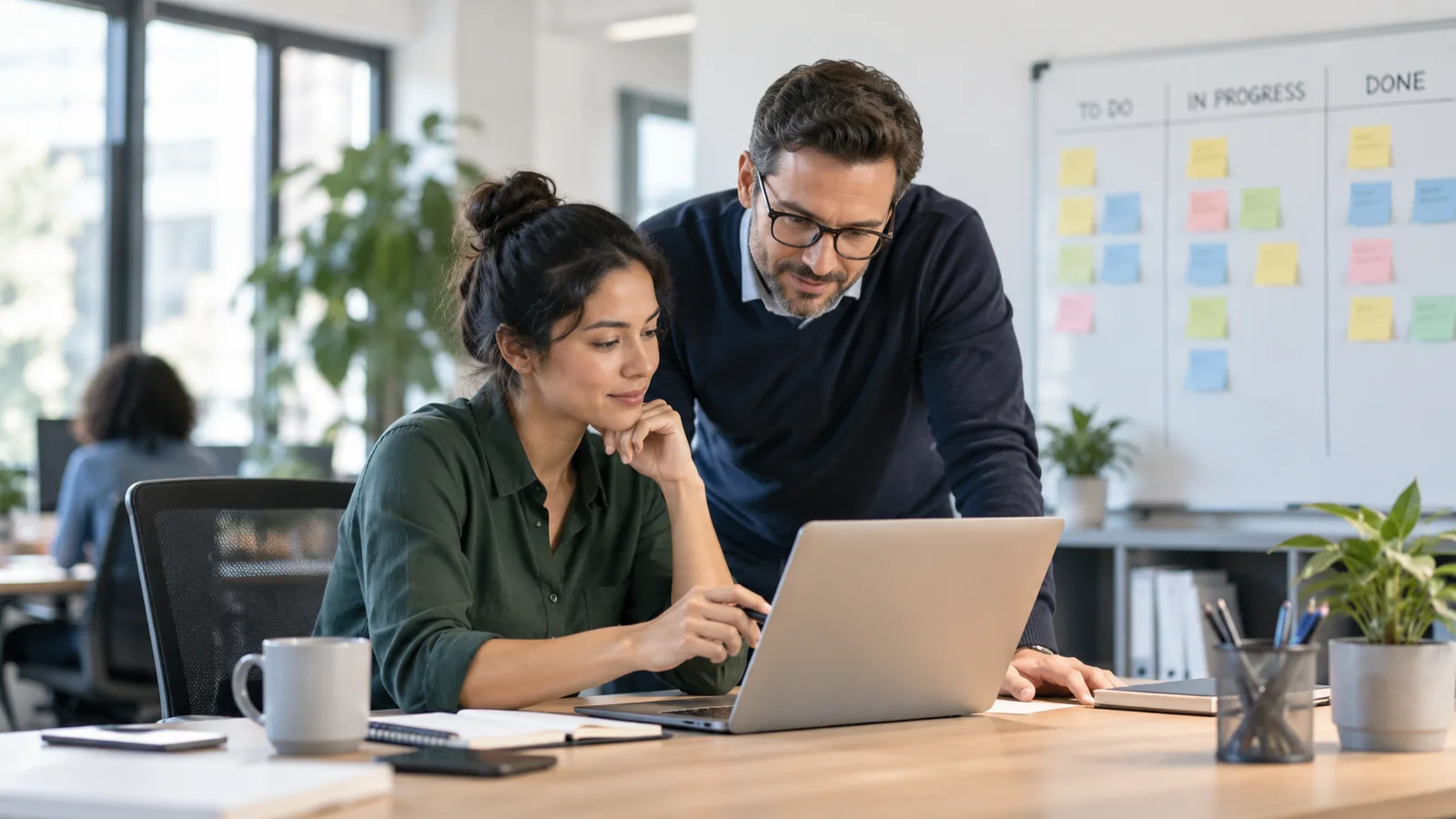 Employee and manager reviewing workload priorities to manage stress at work